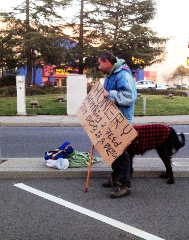 Sorry Jesus.... I just assumed you were on drugs Homeless man with a dog and holding a sign asking for food