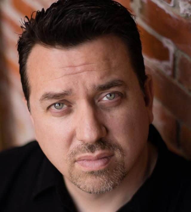 Rondall Reynoso leaning against a wall