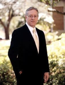 Louisiana College: Judgement shall come Joe Aguillard in a suit with his hand in his pocket