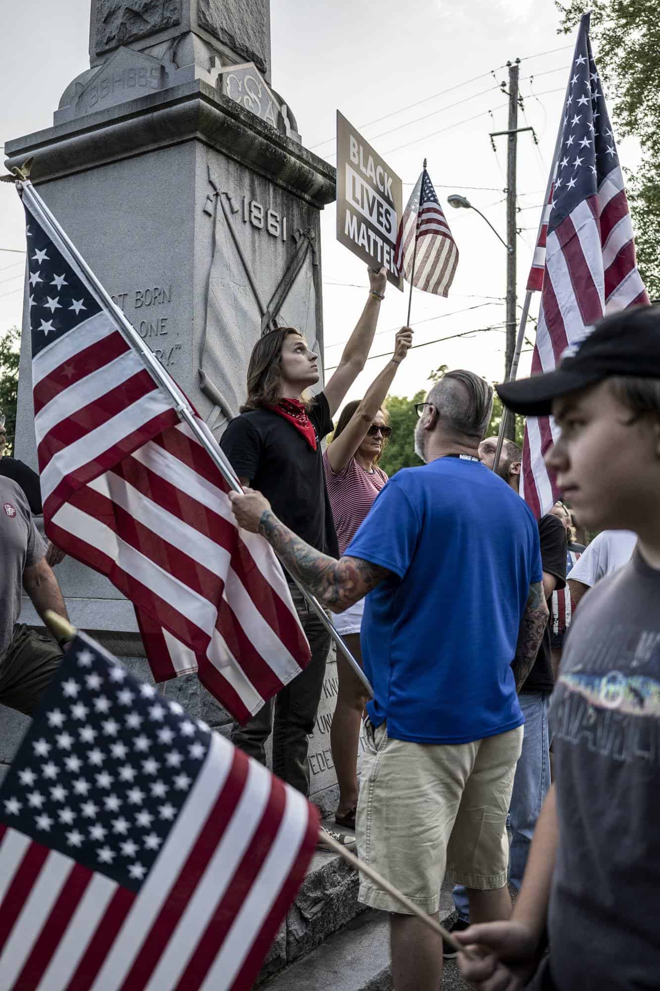 Demonstrator enduring insults from pro-monument protesters.