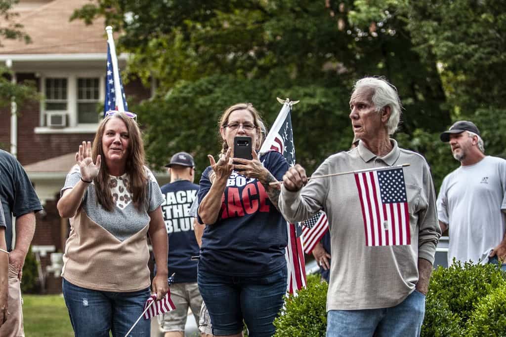 Confederate supporters flipping off the photographer.