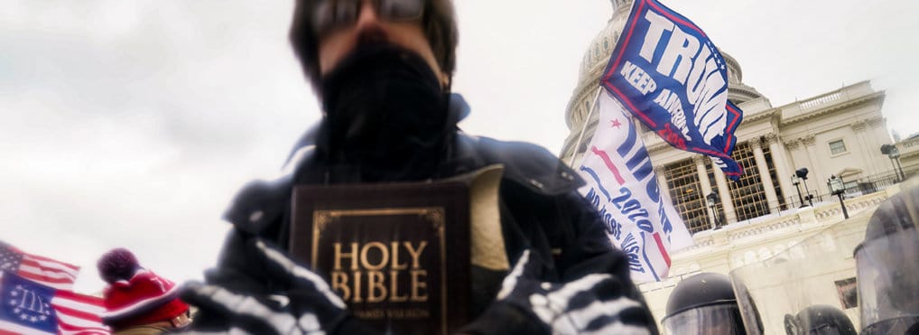 Throwing Religious Violence Out The Window January 6th rioter holding a Bible.