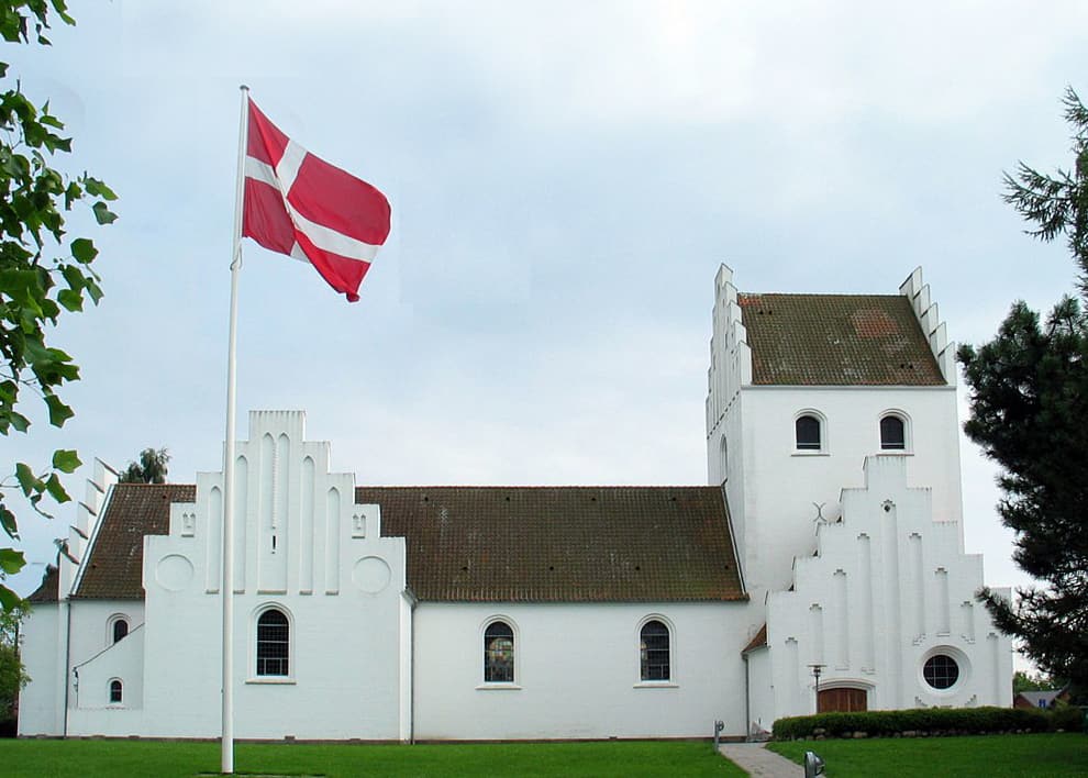 The government wants to tell them what language to preach in. Ministers are objecting. Danish church