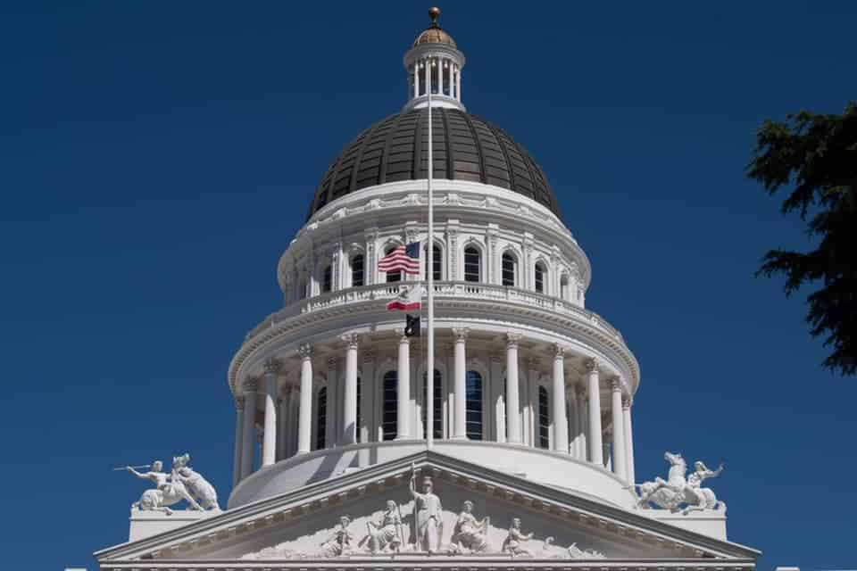 A Father's and Mother's Legacy A US flag at half mast over the CA capitol in Sacramento.