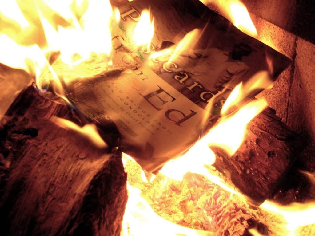 The title page of a book burning in a fire.