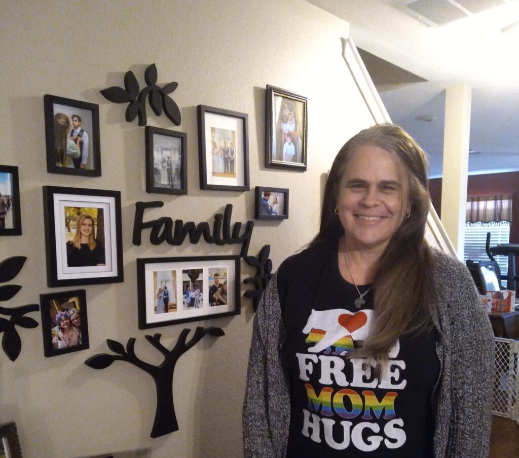 Op-ed: Affirming LGBTQIA+ youth is pro-life woman smiling wearing free mom hugs t-shirt