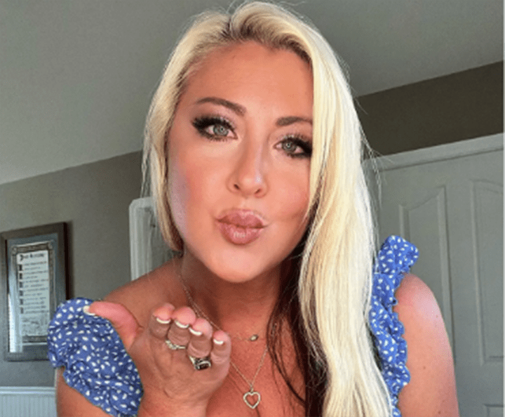 Christian stripper Nita Marie blows a kiss in a screenshot.