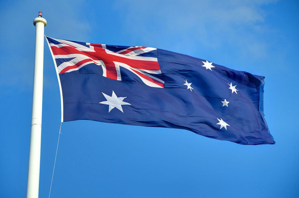 Council looks to replace prayer with 'inclusive affirmation' An Australian flag is shown waving in the wind against a blue sky.