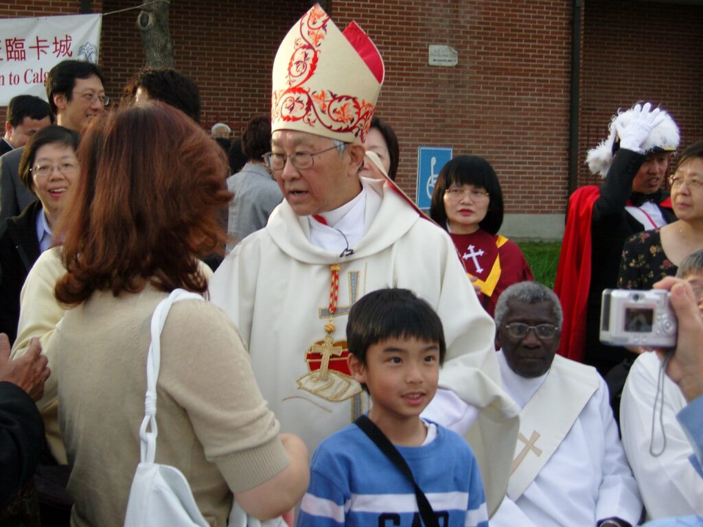 Trial of pro-democracy Catholic cardinal starts in Hong Kong A Catholic cardinal of seemingly Asian decent stands in a crowd speaking to a woman