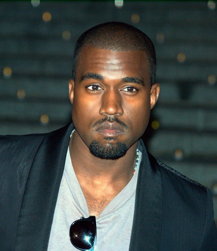 Kanye West to buy Parler Ye, Kanye West, with sunglasses on his neck and a sport coat