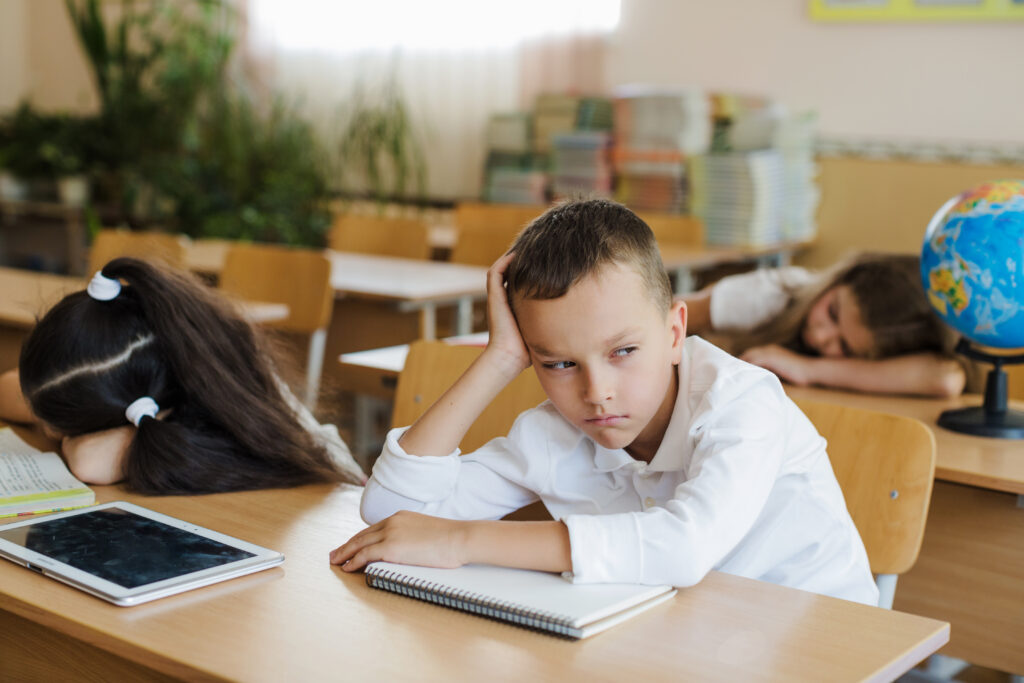 National educational evaluation reveals 'alarming' results boy-sitting-in-classroom-looking-away