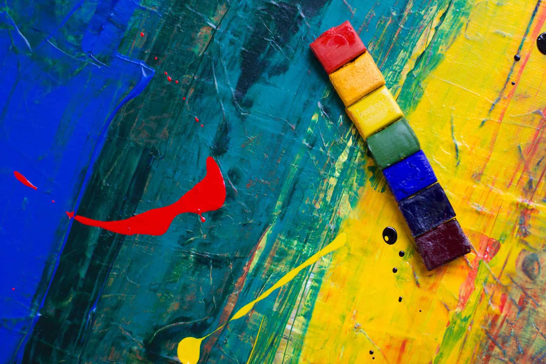 rainbow colored tiles on a colorful painted background