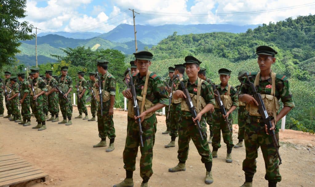 armed men in soldiers uniforms standing in formation