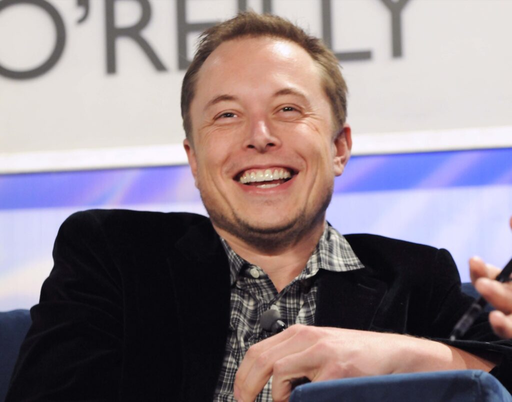 Elon Musk uses Bible to justify not reactivating Alex Jones' Twitter account a front view of Elon Musk with a full smile