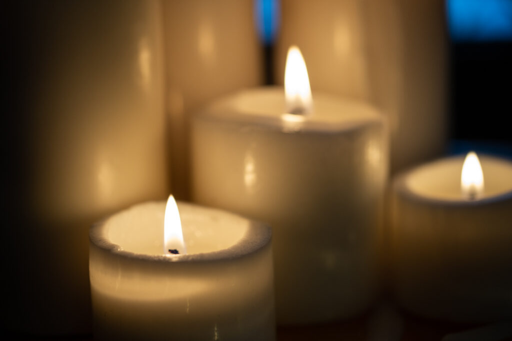 North Dakota woman who died on Christmas 2015, may receive sainthood close up photo of off white and lit pillar candles of various heights are clustered together
