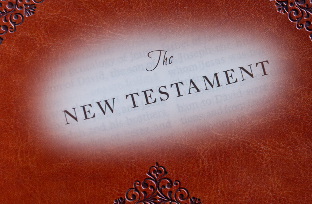 The words The New Testament superimposed upon a Bible cover.