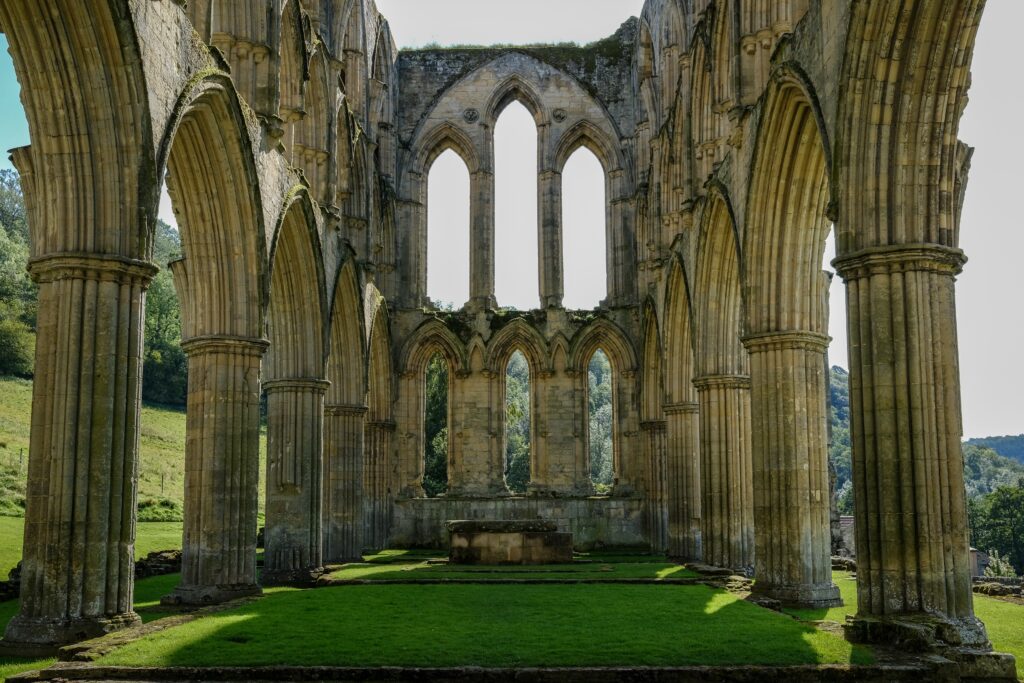 Semper Reformanda? The symbiotic legacies of Christian reformation and education a shell of a stone cathedral surrounded by green grass inside and out