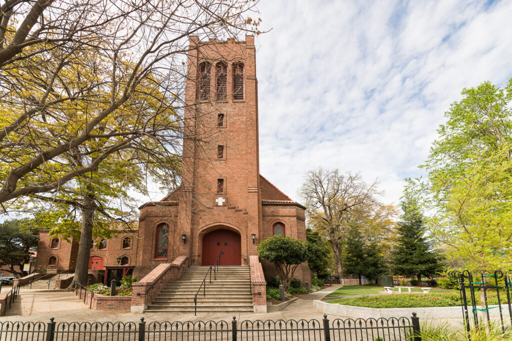 A photo taken from the street of the red brick Bidwell Presbyterian Church in Chico California.