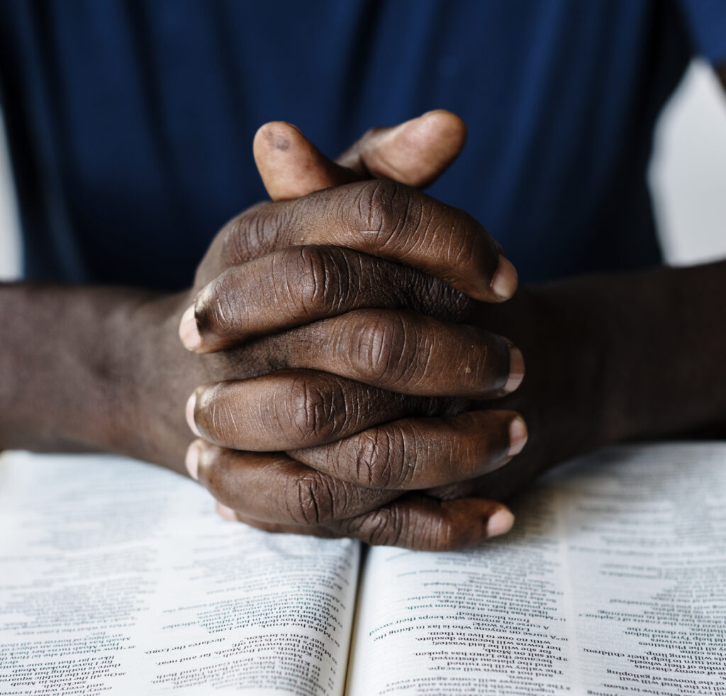 Africa: The story of Pastor Mike and his legacy african-american-male-hands-resting-on-an-open-bible
