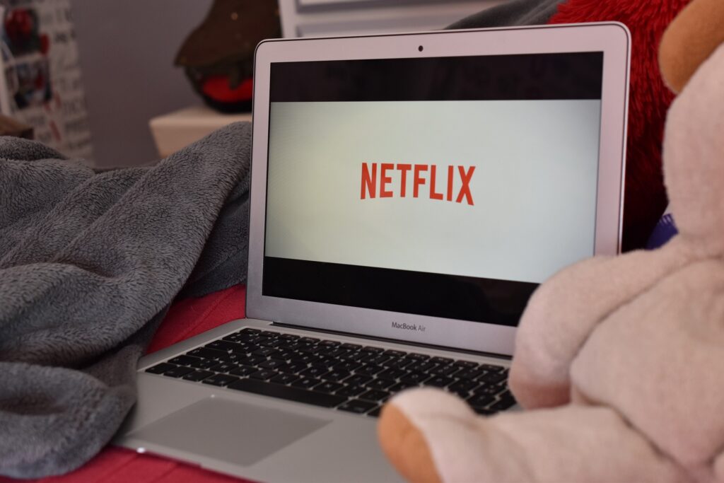 Scottish Catholics urged to prioritise church over football, Netflix A laptop sits in what looks like a home environment with a stuffed bear next to it and the Netflix logo on the screen.