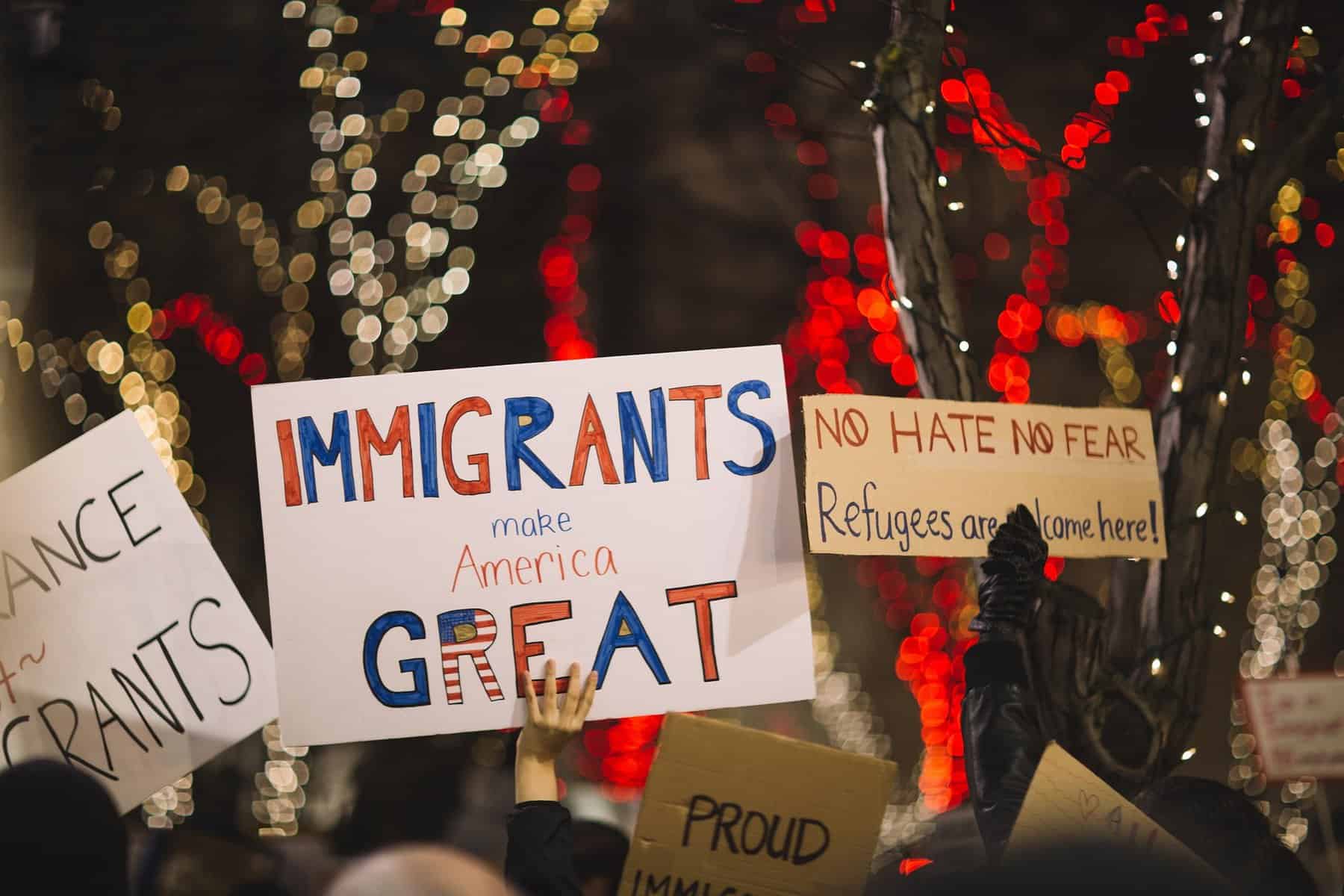 Pro US immigration signs are held in a crowd