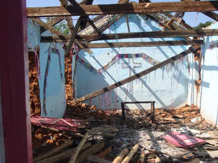 Mobs reportedly seek to enforce India's anti-conversion laws Photo shows what was once an Orissa church with the roof missing and daylight streaming through timbers. The outline of a cross is shown on a blue wall.