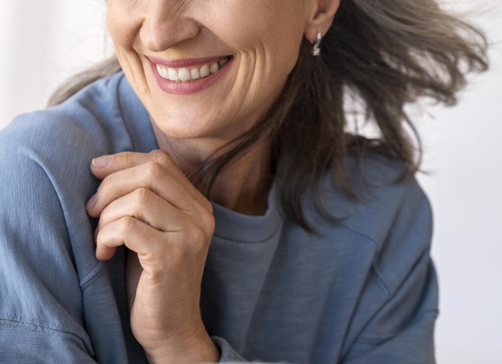Kidney gives woman with PKD a second chance A woman is shown from under the eyes down to clavicle wearing a blue sweatshirt and smiling.