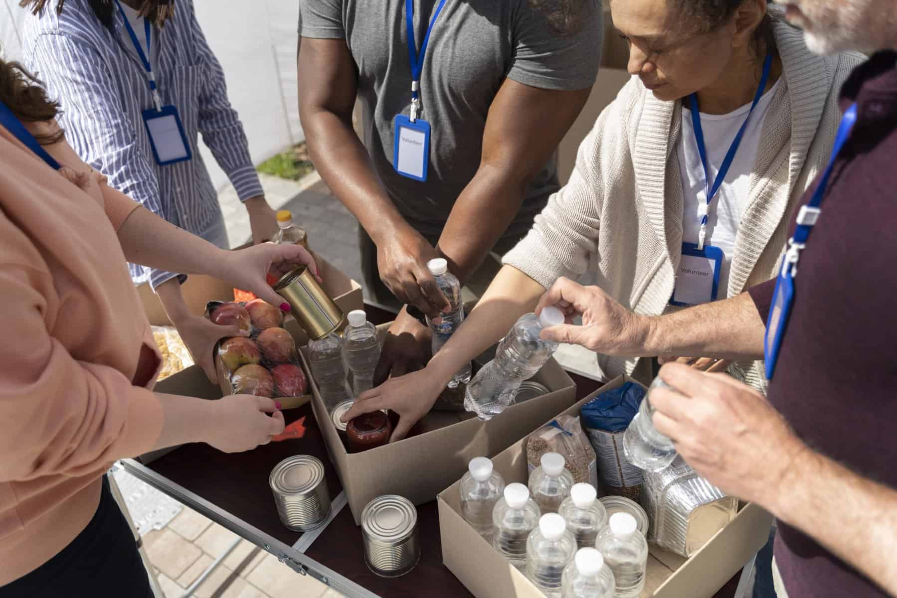 People surround food distribution boxes.
