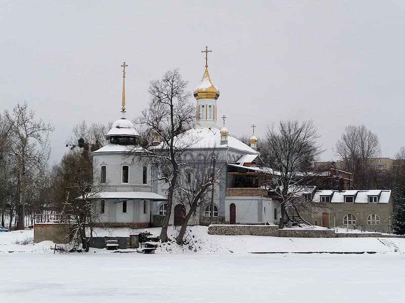 An Orthodox church is seen from the street on a snowy day.