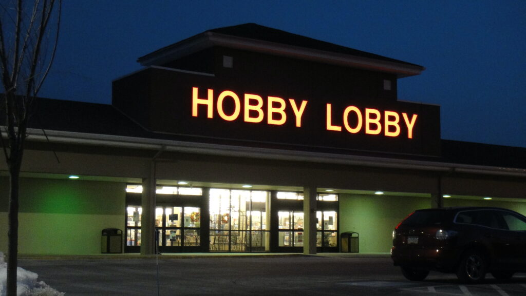 A Hobby Lobby store front is seen lit up at night.