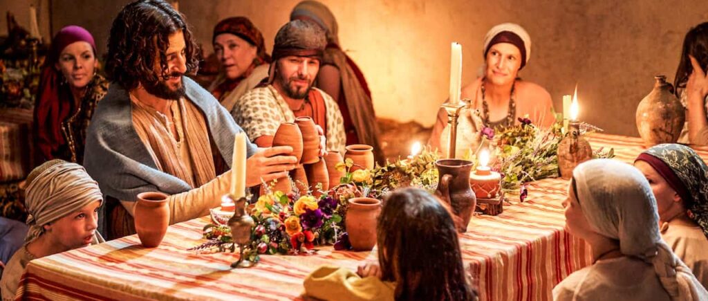The cast of The Chosen sit around a table.