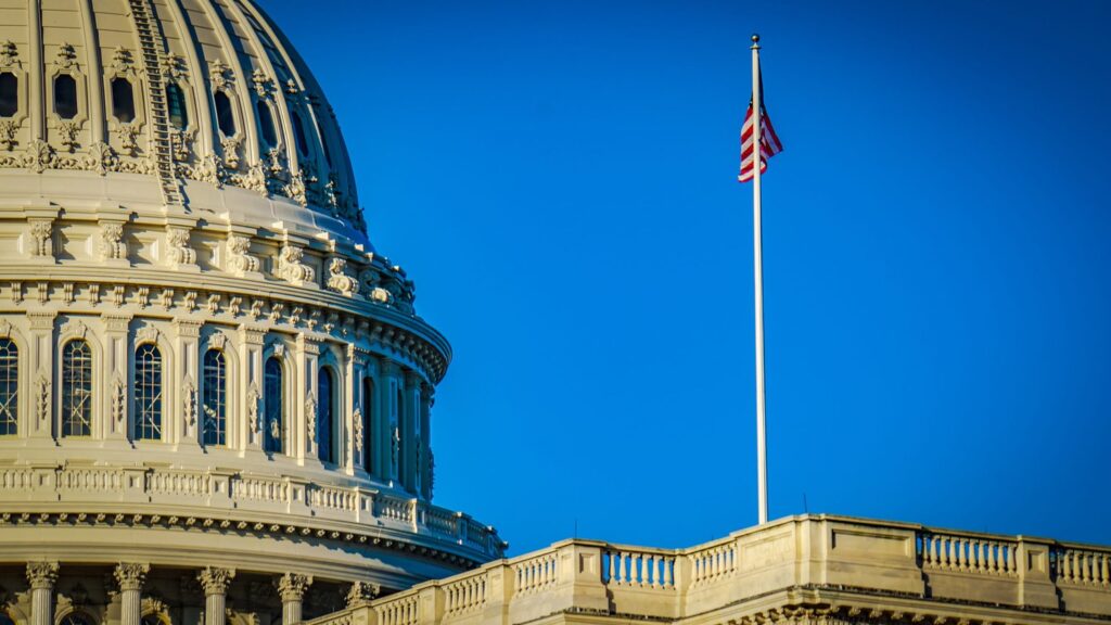 Christian nationalism criticized as election season approaches A portion of the US Capitol dome in DC is shown with a flag pole holding the US flag to it's right.