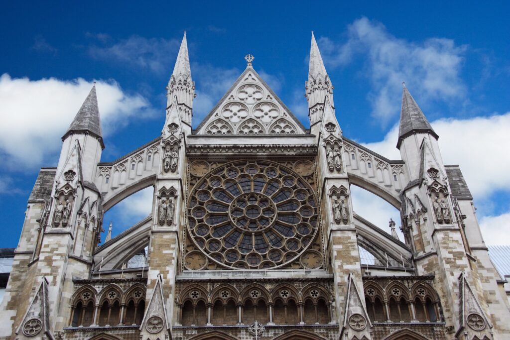 An old ornate stone church face with a rose window is shown.