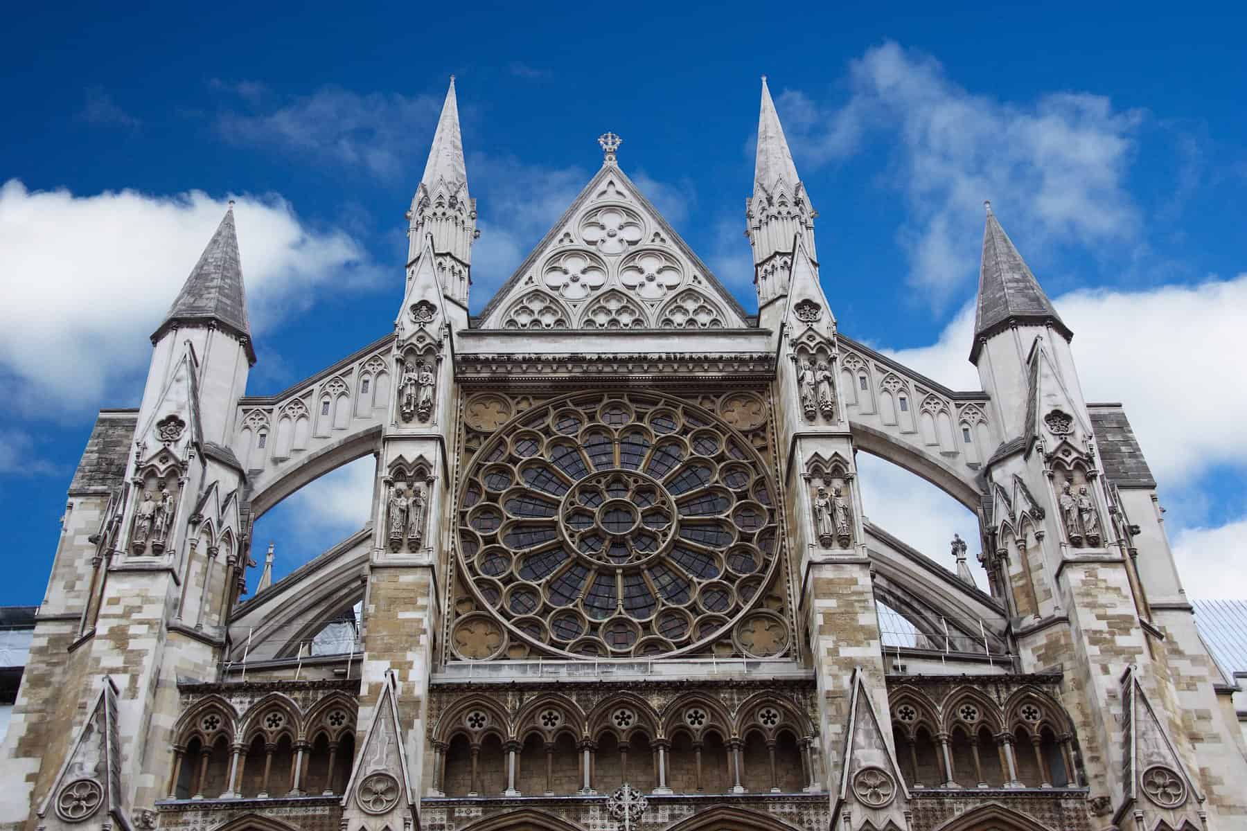 An old ornate stone church face with a rose window is shown.