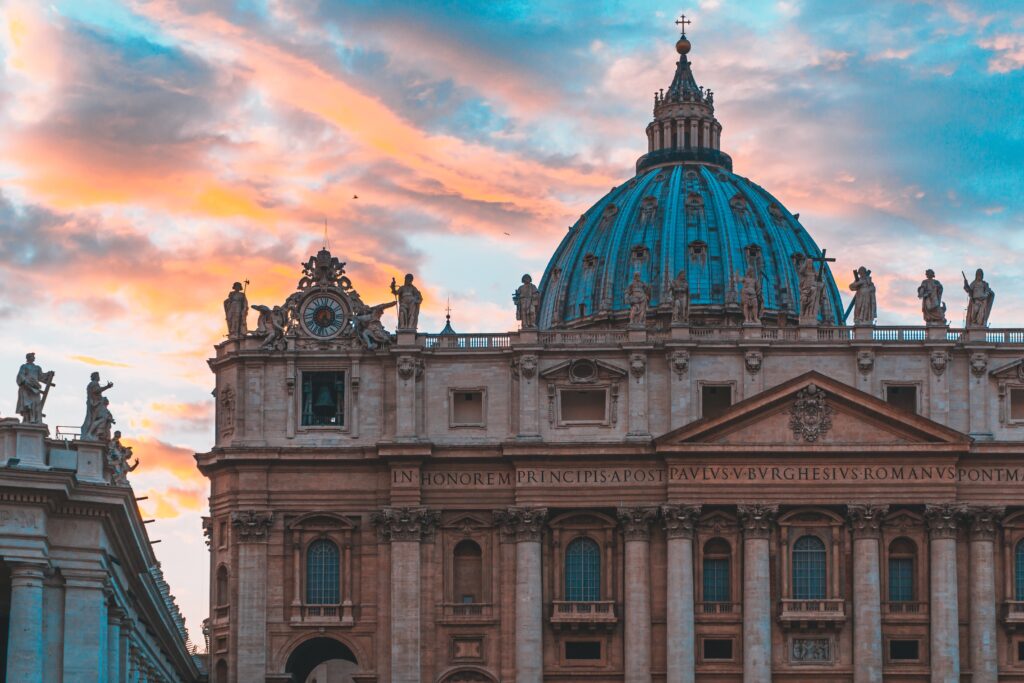 Vatican prosecutor seeks prison and fine for cardinal Famous St. Peter's Basilica in Vatican City and the sky with beautiful colors behind