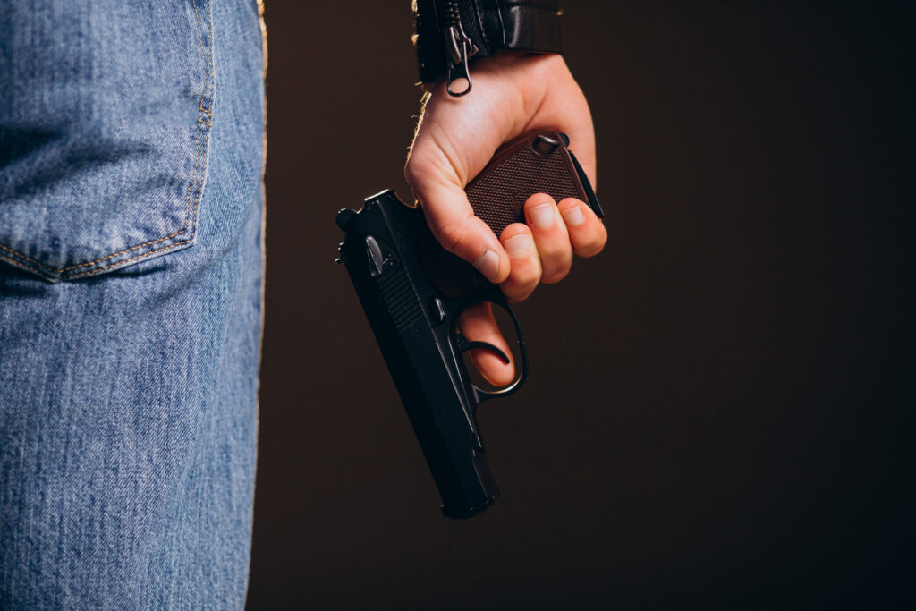 Pittsburgh synagogue gunman may receive death penalty Part of a man's torso is shown from the rear with his hand at his side holding a handgun.