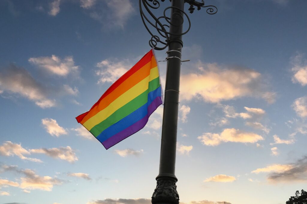 Russian lawmakers propose legislation to tighten restrictions on transgender rights A pride flag is shown waving in the breeze atop an ornate flagpole.