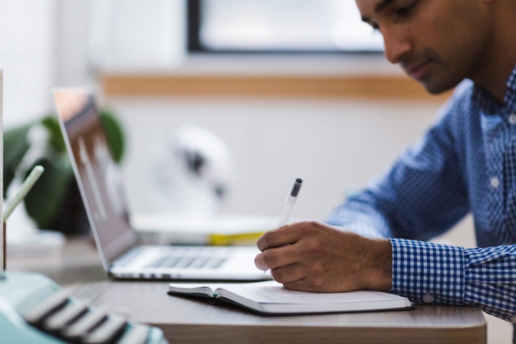 Ohio Church collaborates with researchers to study effects of chemical spill and train derailment A man sits at desk with a computer and holds a pen over paper.