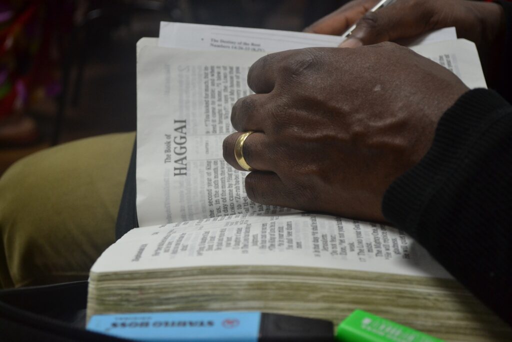 Black Americans lead in church attendance and ‘spiritual vitality’ A Black man's hands are seen thumbing through a Bible showing the cover page for the book of Haggai.