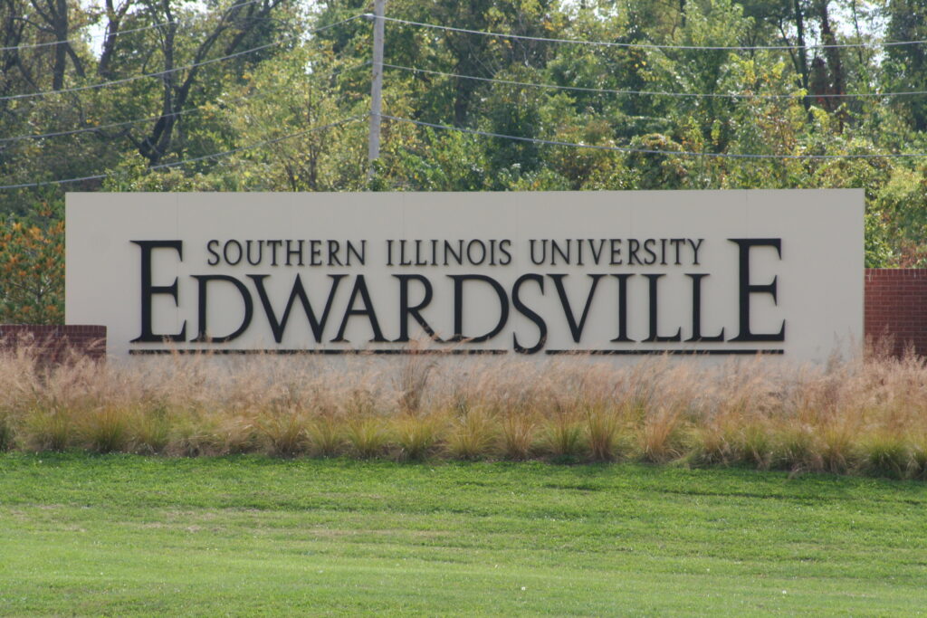 The sign for Southern Illinois University at Edwardsville is shown surrounded by grass.