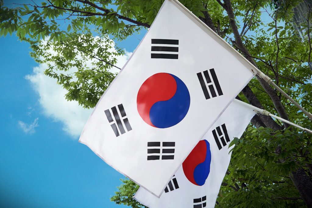 Seoul, South Korea chosen as host for 2027’s World Youth Day Two South Korean flags are shown one behind the other on flagpoles.