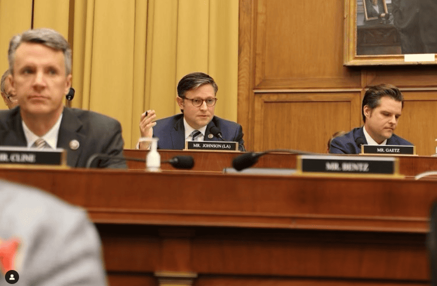 Speaker Mike Johnson and the painful cost of "Heroism" Mike Johnson is shown sitting in a chamber room.