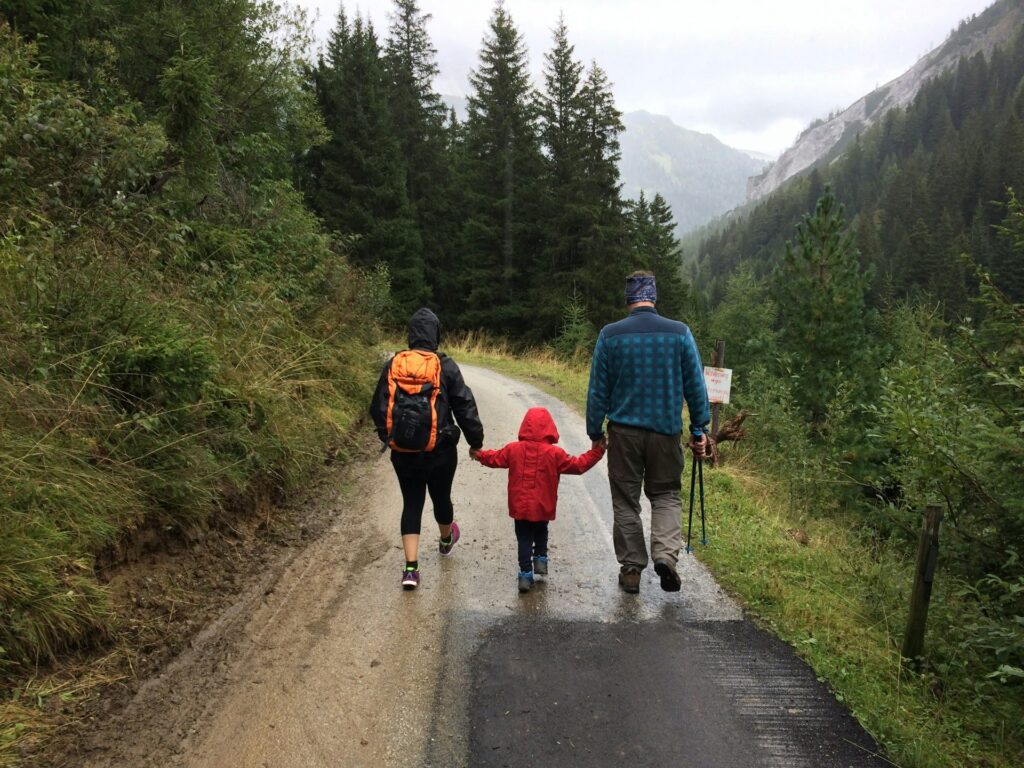 Abortion and family policy: The GOPโs post-Dobbs pivot Two adults and a child walk away from a camera on a wet day on an apparent hike.