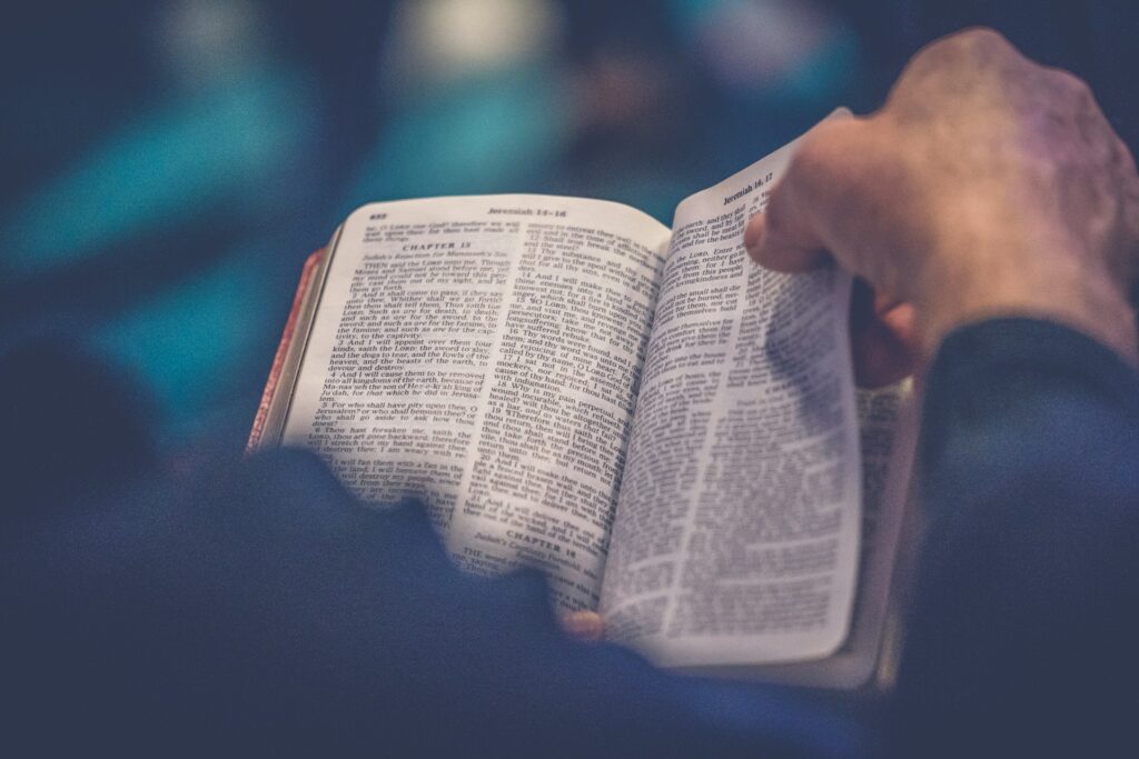 Free Bibles and digital plans: New trends in encouraging scripture reading An open Bible sits on a man's lap as he begins to turn a page.