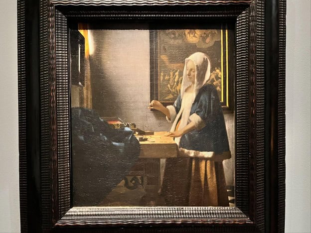 Woman Holding a Balance by Vermeer