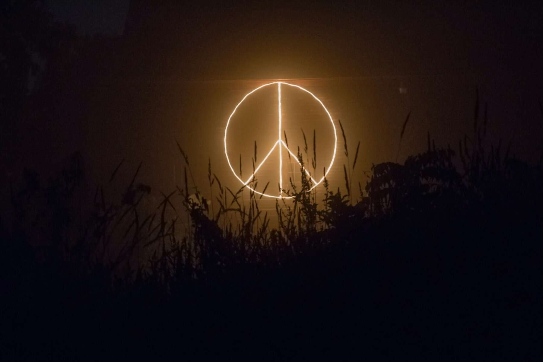 An illuminated peace symbol.