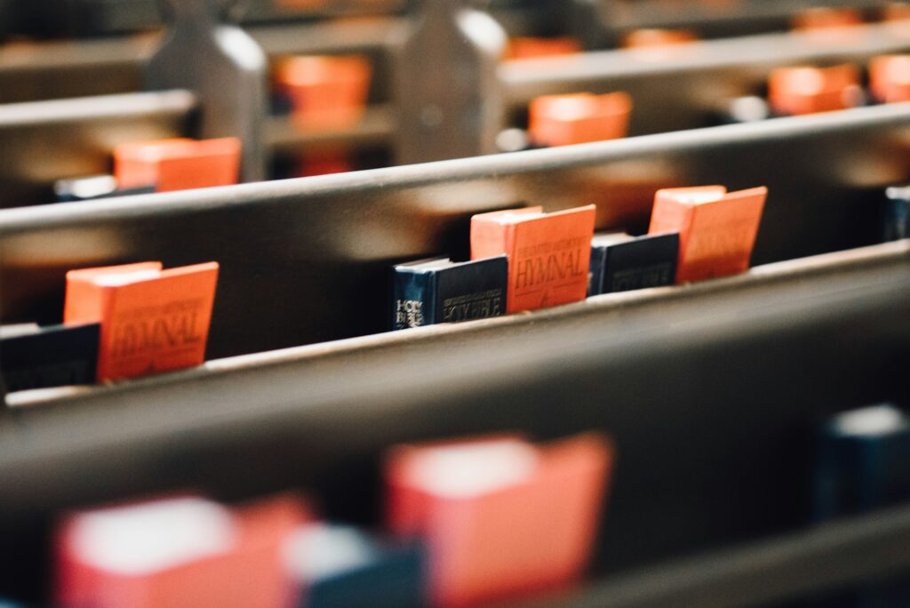 The back of a pew with hymnals.