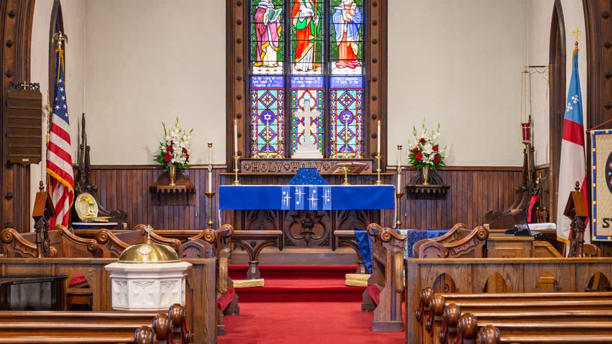 Episcopal church altar with the American flag to the left.