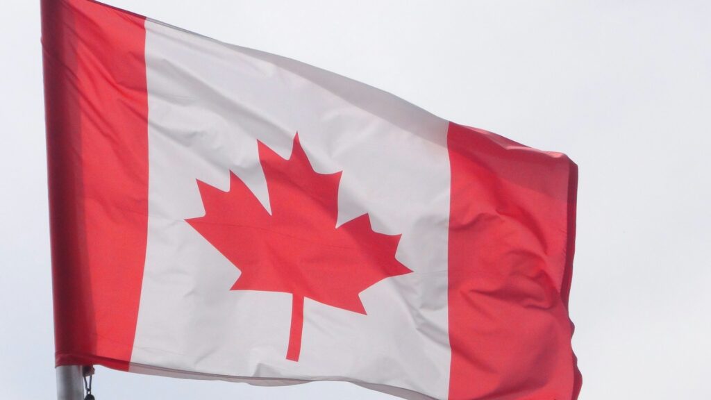 A Canadian flag waving in the breeze.