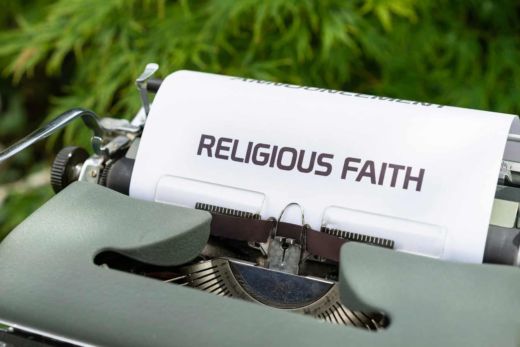 A typewriter with a paper saying Religious Faith.